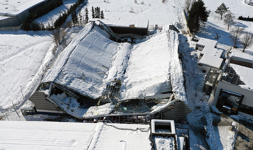 Roof,Collapsed,Under,The,Weight,Of,Snow.,Aerial,View,Of